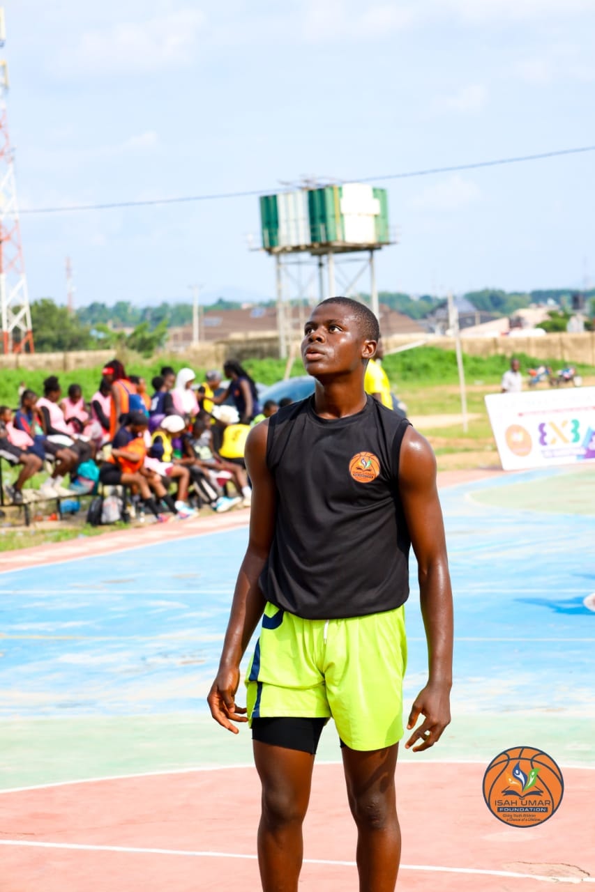 Young male player in black jersey gazing upward on the 3X3 Championship court
