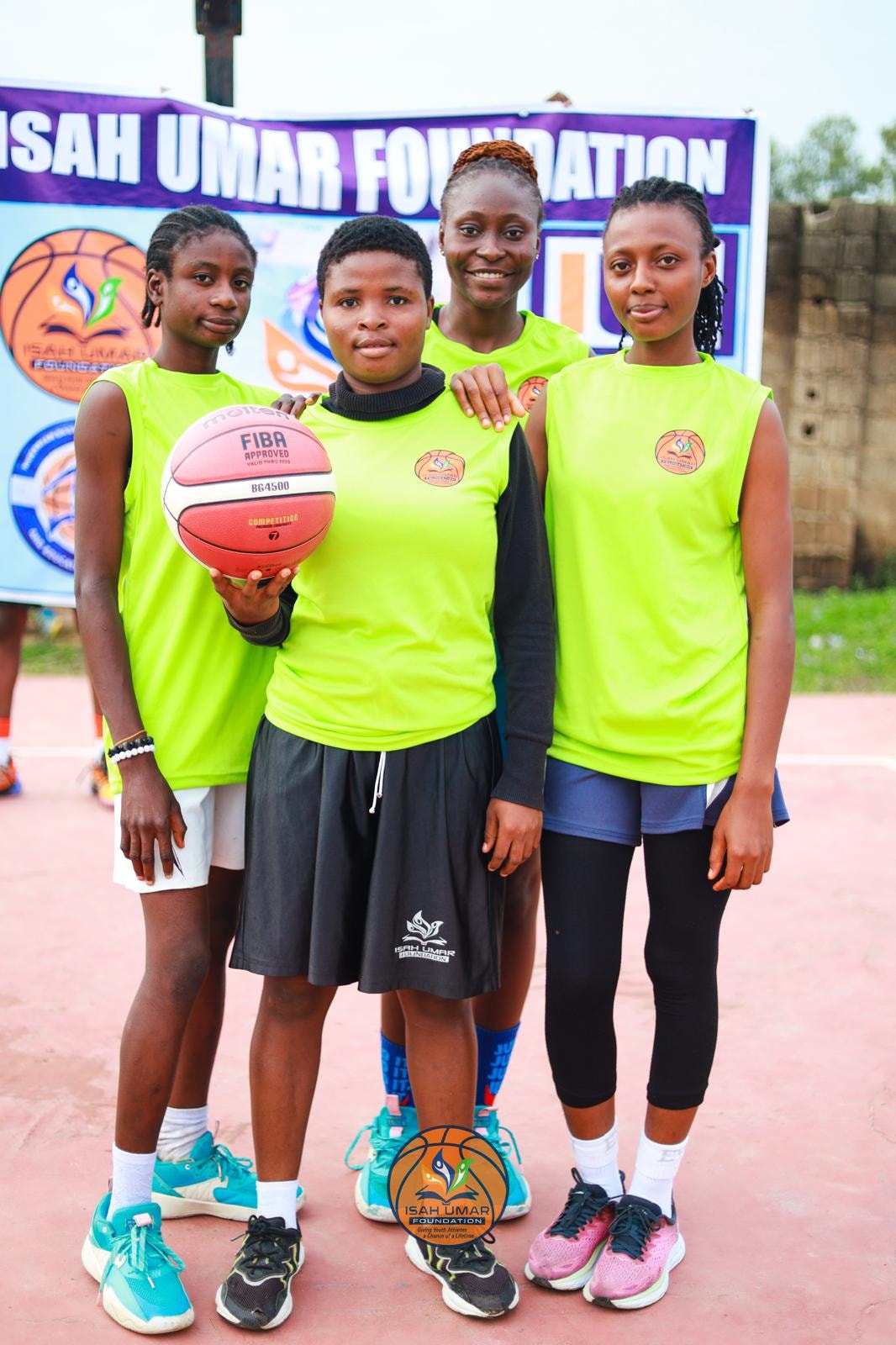 Female team in neon green jerseys holding a FIBA-approved ball at the 3X3 Championship