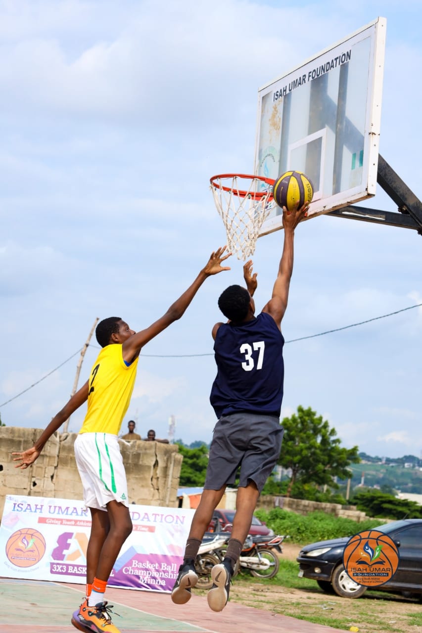 Player #37 going up for a layup against a defender at the IUF 3X3 Basketball Championship, Minna